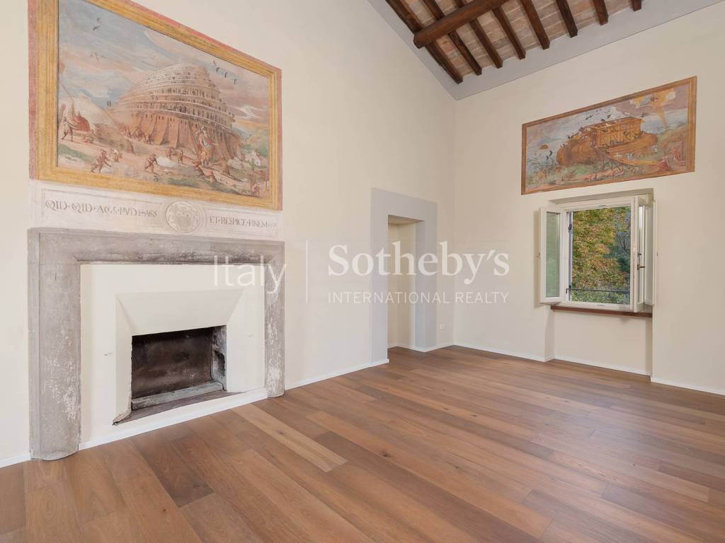 room with frescoed walls and marble fireplace